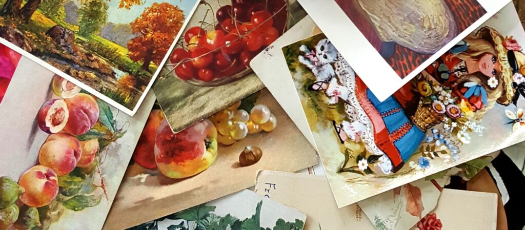 An assortment of vintage postcards featuring, among other things, paintings of fruit