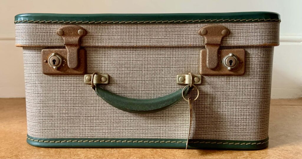 A mid--20th entury grey suitcase with green handle and trim, and rusty hinges